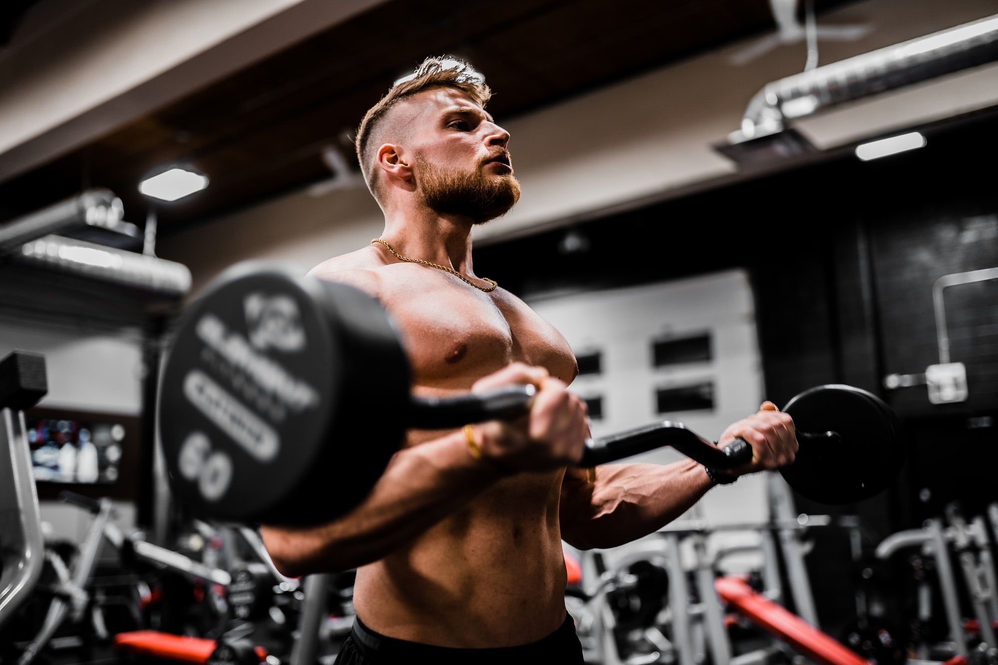 Bodybuilder working out at a gym signifying heavy lifting